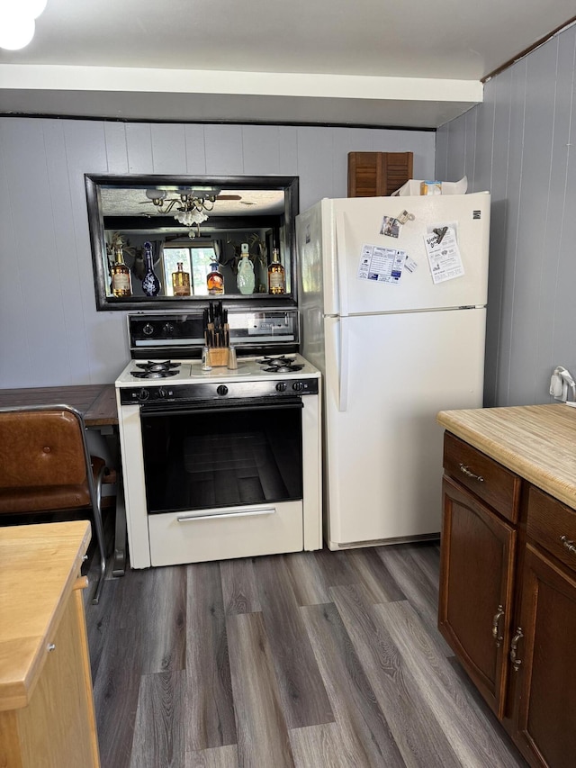 2493 S Horseshoe Trl, Grayling, MI 49738 - kitchen with white appliances, wooden counters, and dark wood-style floors