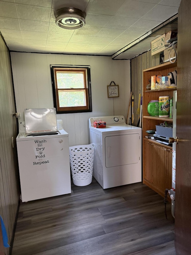 2493 S Horseshoe Trl, Grayling, MI 49738 - laundry room with dark wood-type flooring, washing machine and dryer, and wooden walls