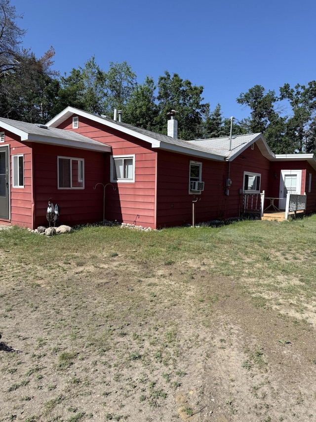 2493 S Horseshoe Trl, Grayling, MI 49738 - view of side of property with a chimney, cooling unit, and a yard
