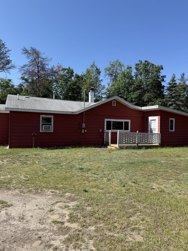 2493 S Horseshoe Trl, Grayling, MI 49738 - back of property featuring a chimney and a lawn