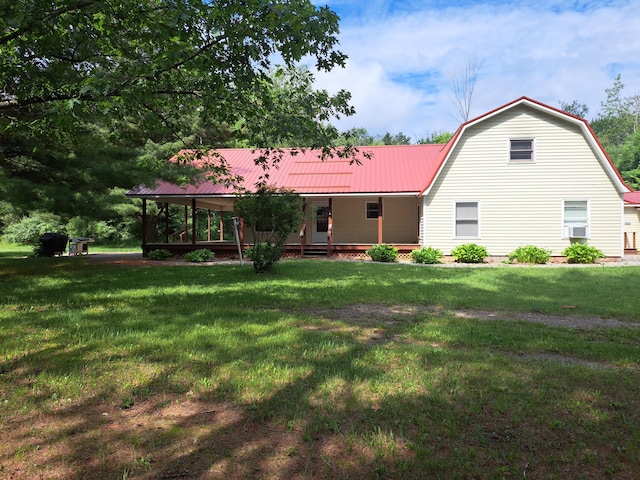 4160 S Vaughn Lake Rd, Glennie, MI 48737 - view of front of house with a porch, a front yard, a metal roof, and a gambrel roof