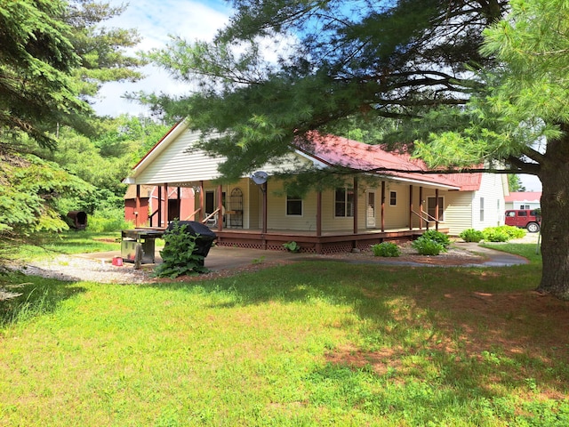 4160 S Vaughn Lake Rd, Glennie, MI 48737 - back of house featuring a porch and a yard