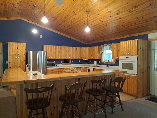 4160 S Vaughn Lake Rd, Glennie, MI 48737 - kitchen featuring appliances with stainless steel finishes, vaulted ceiling, light colored carpet, light countertops, and wood ceiling