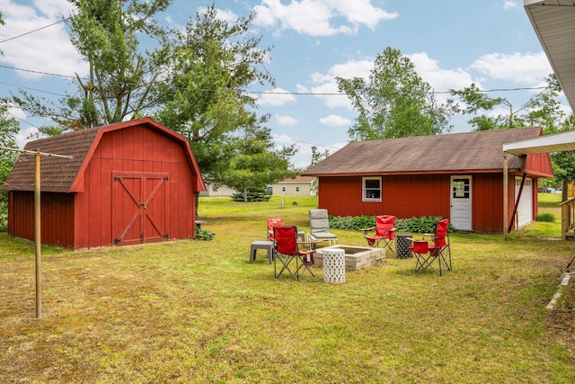 2731 Gregory St, Lewiston, MI 49756 - view of green lawn with a fire pit and a shed