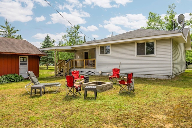 2731 Gregory St, Lewiston, MI 49756 - rear view of property featuring an outdoor fire pit and a lawn