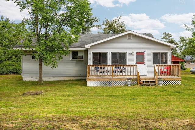 2731 Gregory St, Lewiston, MI 49756 - back of property featuring a deck, a lawn, cooling unit, and roof with shingles