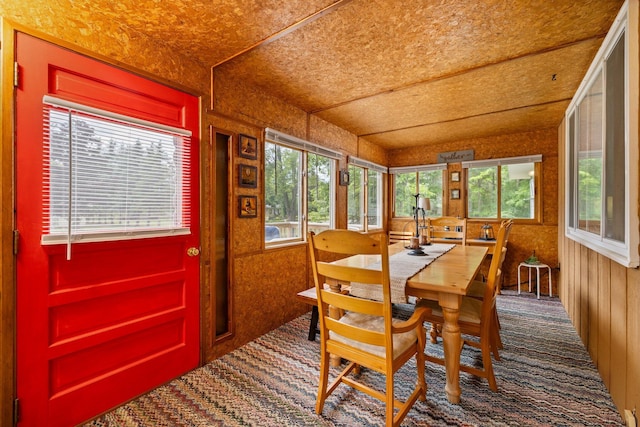2731 Gregory St, Lewiston, MI 49756 - carpeted dining area with plenty of natural light and wooden walls