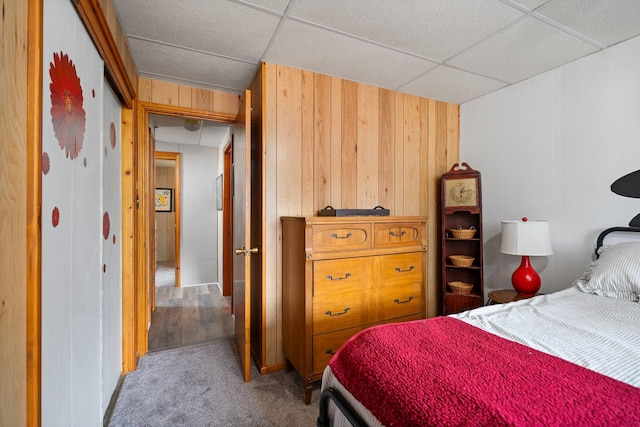 2731 Gregory St, Lewiston, MI 49756 - carpeted bedroom with wood walls and a paneled ceiling