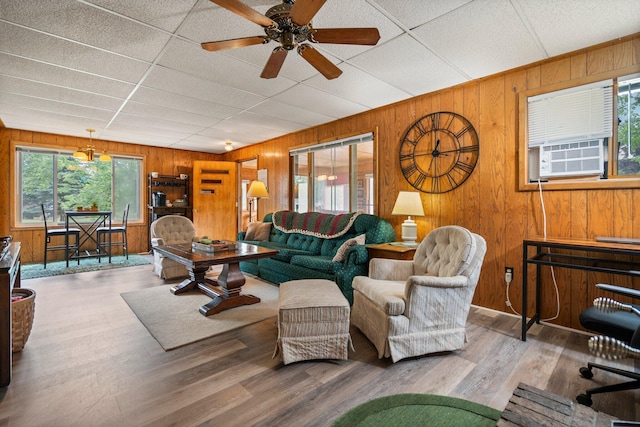 2731 Gregory St, Lewiston, MI 49756 - living area featuring wood walls, ceiling fan, wood finished floors, and cooling unit