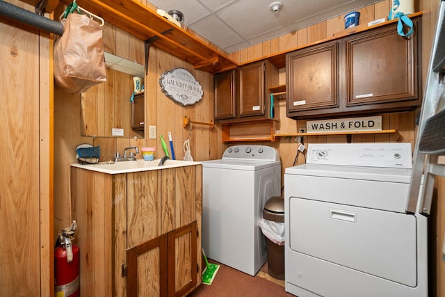 2731 Gregory St, Lewiston, MI 49756 - washroom with washer and dryer, cabinet space, wooden walls, and carpet floors