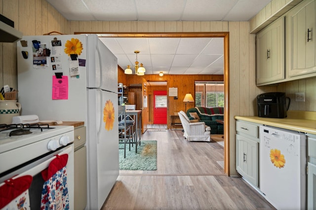2731 Gregory St, Lewiston, MI 49756 - kitchen with white appliances, wood walls, light wood-style floors, a paneled ceiling, and light countertops