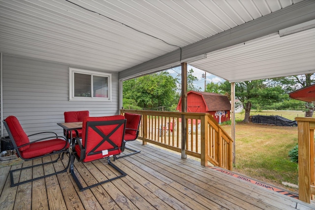 2731 Gregory St, Lewiston, MI 49756 - deck featuring a shed, outdoor dining space, and a lawn