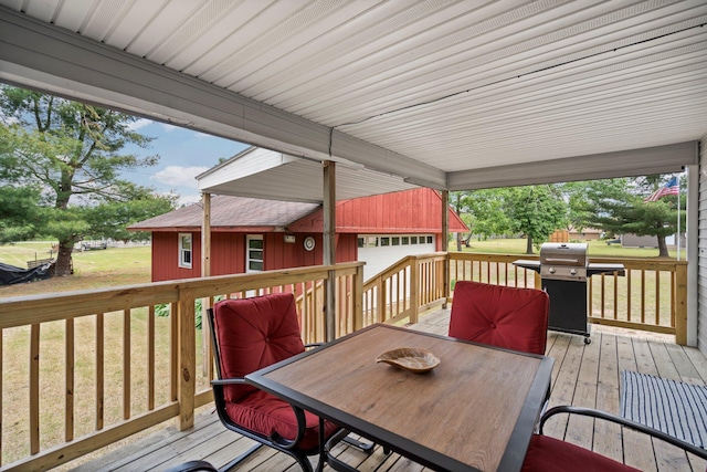 2731 Gregory St, Lewiston, MI 49756 - deck with a grill, outdoor dining space, a lawn, and an outdoor structure