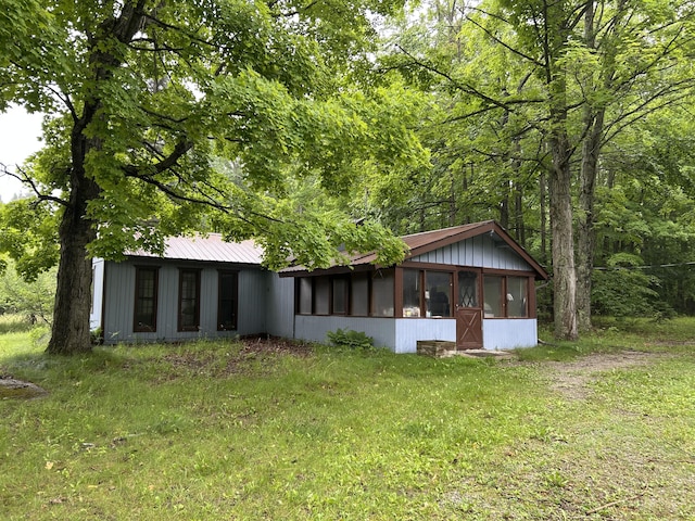16831 Moores Landing Rd, Lachine, MI 49753 - rear view of house with a sunroom