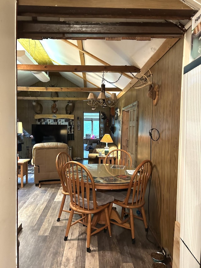 16831 Moores Landing Rd, Lachine, MI 49753 - dining area featuring wood walls, hardwood / wood-style floors, and a chandelier