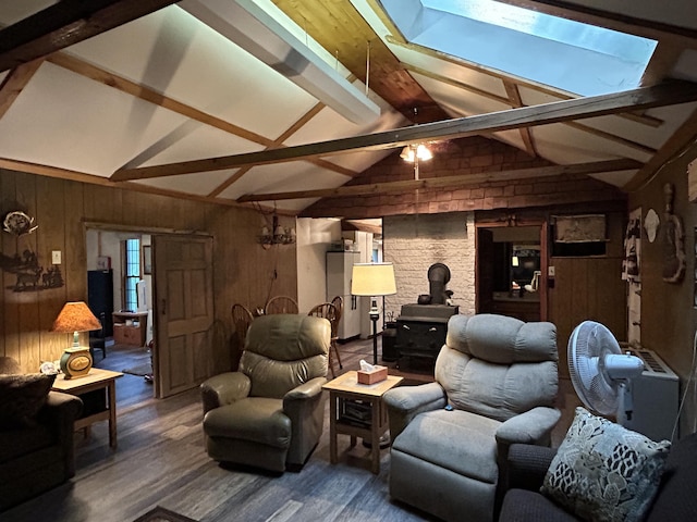 16831 Moores Landing Rd, Lachine, MI 49753 - living area featuring a wood stove, wooden walls, and wood finished floors