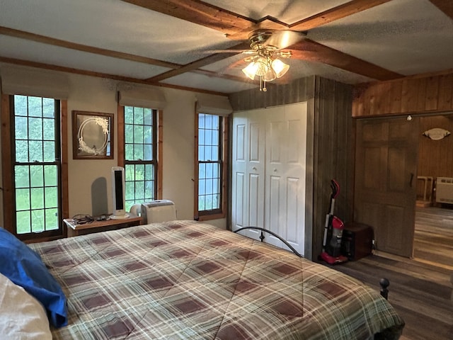 16831 Moores Landing Rd, Lachine, MI 49753 - bedroom featuring wood finished floors, multiple windows, and wood walls