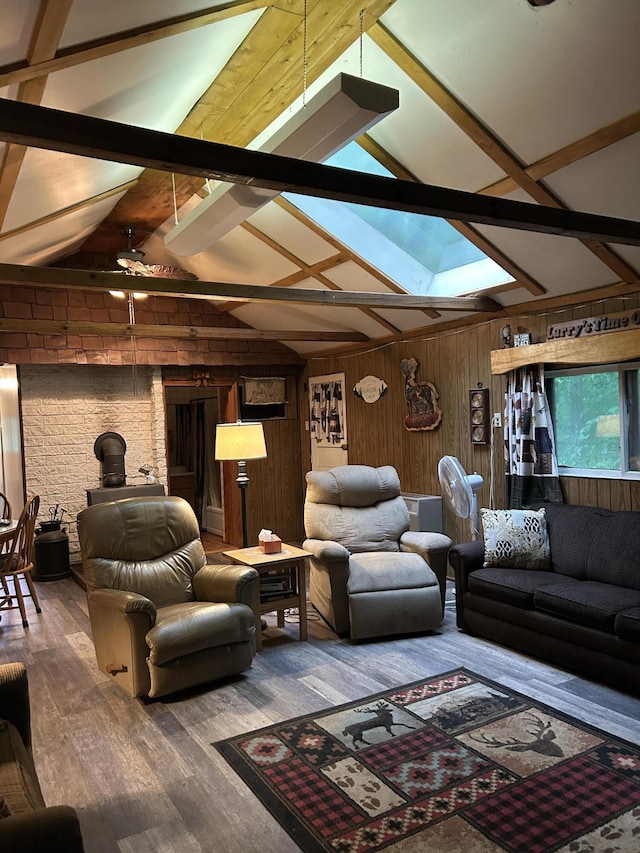 16831 Moores Landing Rd, Lachine, MI 49753 - living room featuring a skylight, wooden walls, wood finished floors, and a wood stove