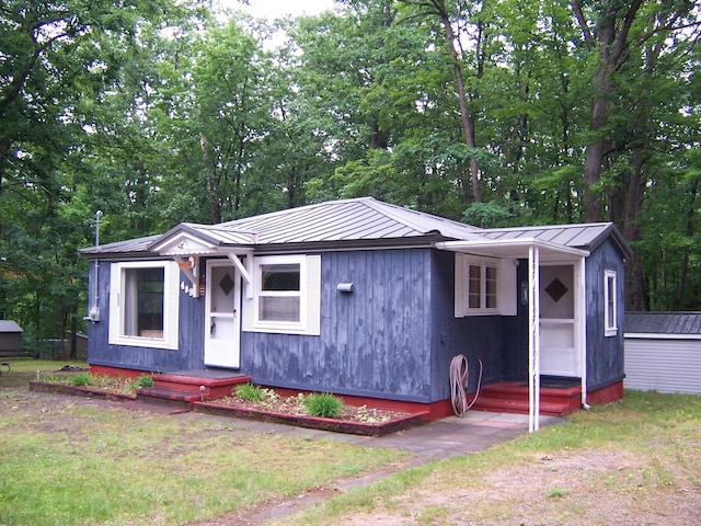409 Marvin Rd, Roscommon, MI 48653 - view of front of home with a metal roof