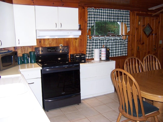 409 Marvin Rd, Roscommon, MI 48653 - kitchen featuring black electric range oven, custom exhaust hood, stainless steel microwave, light countertops, and white cabinetry