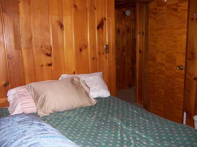 409 Marvin Rd, Roscommon, MI 48653 - bedroom with wood walls and carpet flooring