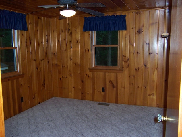 409 Marvin Rd, Roscommon, MI 48653 - empty room with wood walls, carpet, wooden ceiling, and a ceiling fan