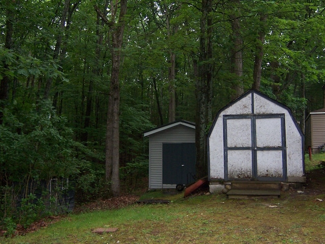 409 Marvin Rd, Roscommon, MI 48653 - view of shed with a forest view