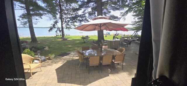1161 Lagoon St, Lewiston, MI 49756 - view of patio / terrace featuring outdoor dining area and a water view