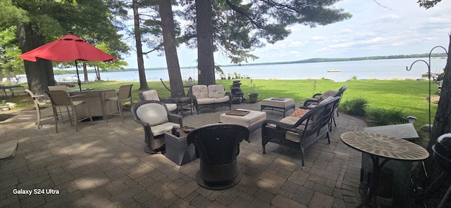 1161 Lagoon St, Lewiston, MI 49756 - view of patio / terrace featuring a water view and a fire pit