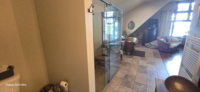 1161 Lagoon St, Lewiston, MI 49756 - corridor with stone tile floors and lofted ceiling