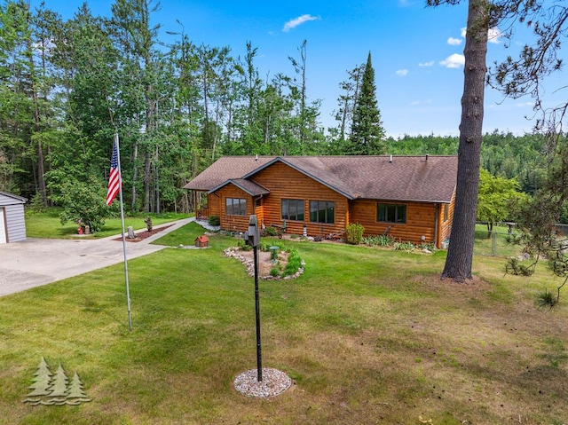 881 N Red Oak Rd, Lewiston, MI 49756 - cabin with an outbuilding, driveway, and a shingled roof