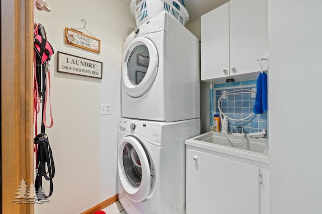 881 N Red Oak Rd, Lewiston, MI 49756 - laundry area featuring cabinet space and stacked washing machine and dryer