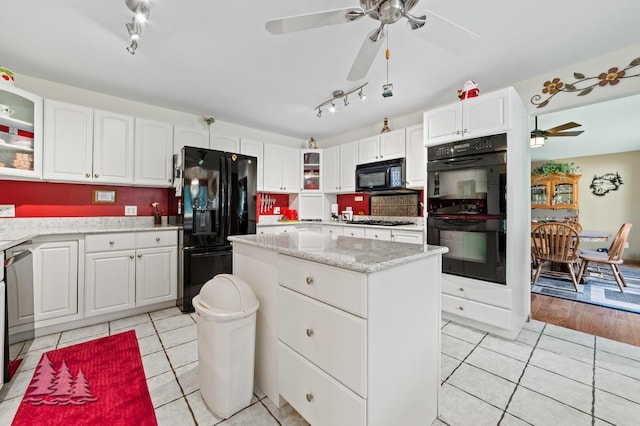 881 N Red Oak Rd, Lewiston, MI 49756 - kitchen featuring black appliances, a ceiling fan, track lighting, light tile patterned flooring, and glass insert cabinets