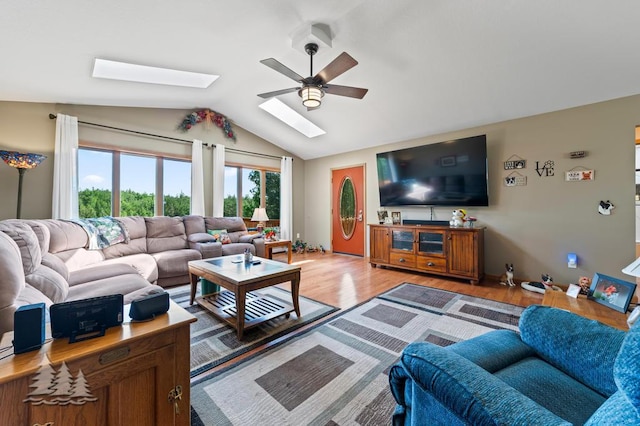 881 N Red Oak Rd, Lewiston, MI 49756 - living area featuring a ceiling fan, a skylight, light wood finished floors, and lofted ceiling