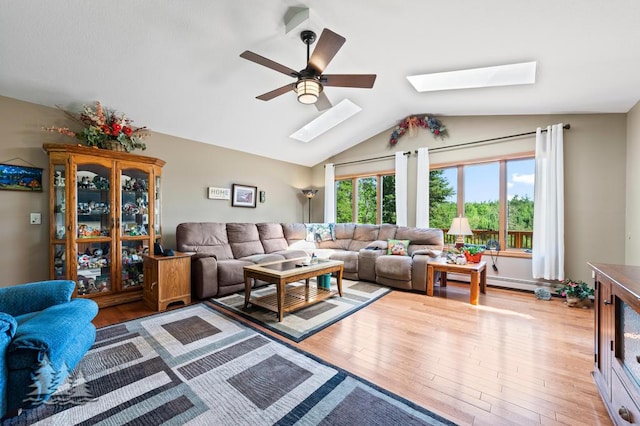 881 N Red Oak Rd, Lewiston, MI 49756 - living area featuring a skylight, wood finished floors, ceiling fan, and vaulted ceiling