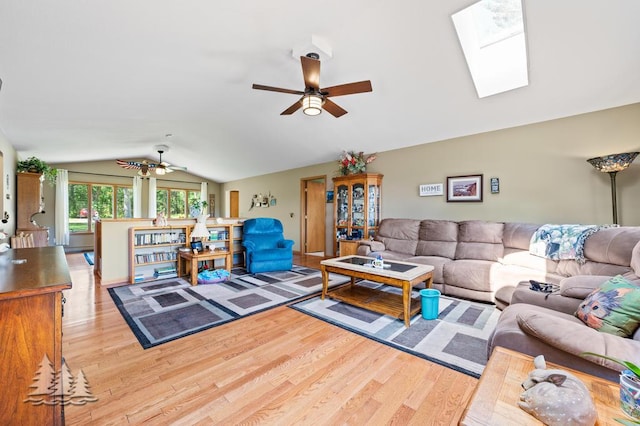 881 N Red Oak Rd, Lewiston, MI 49756 - living area featuring ceiling fan, vaulted ceiling, wood finished floors, and a skylight