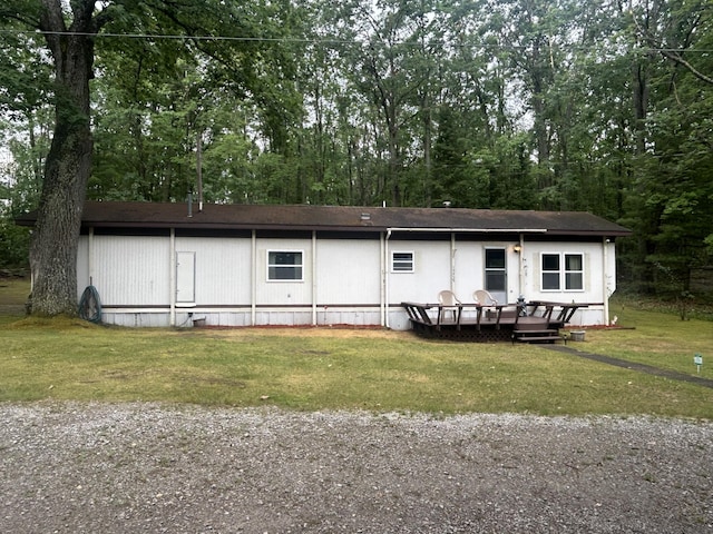 15939 Hiawatha Trl, Atlanta, MI 49709 - view of front of home with a front yard, a deck, and view of scattered trees