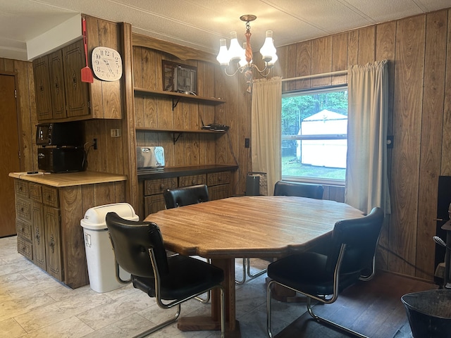 15939 Hiawatha Trl, Atlanta, MI 49709 - dining room with a chandelier and wood walls