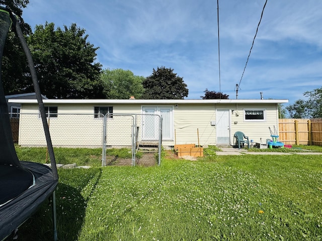 326 N Addison St, Alpena, MI 49707 - rear view of house with a trampoline