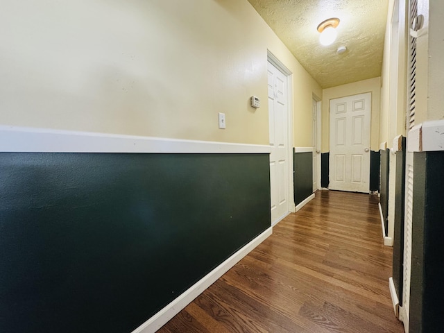 326 N Addison St, Alpena, MI 49707 - hall with wood finished floors and a textured ceiling
