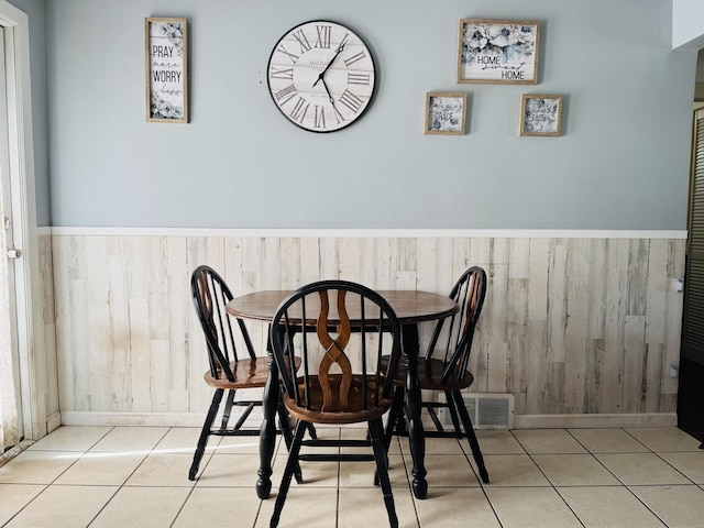 326 N Addison St, Alpena, MI 49707 - dining space with wainscoting and tile patterned flooring