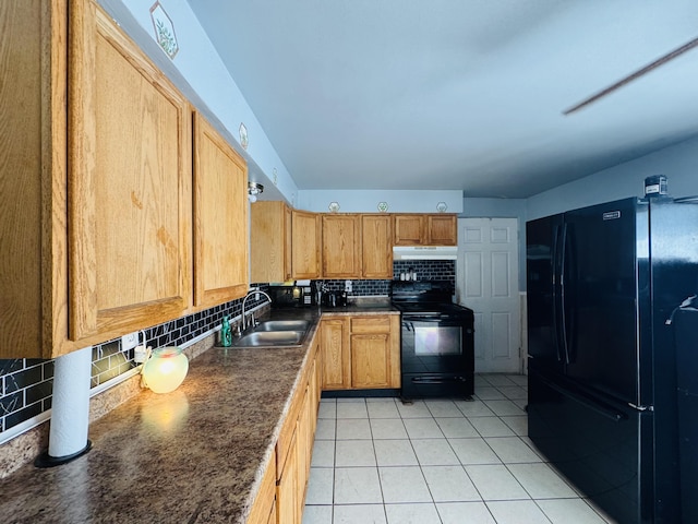 326 N Addison St, Alpena, MI 49707 - kitchen with black appliances, decorative backsplash, under cabinet range hood, dark countertops, and light tile patterned floors