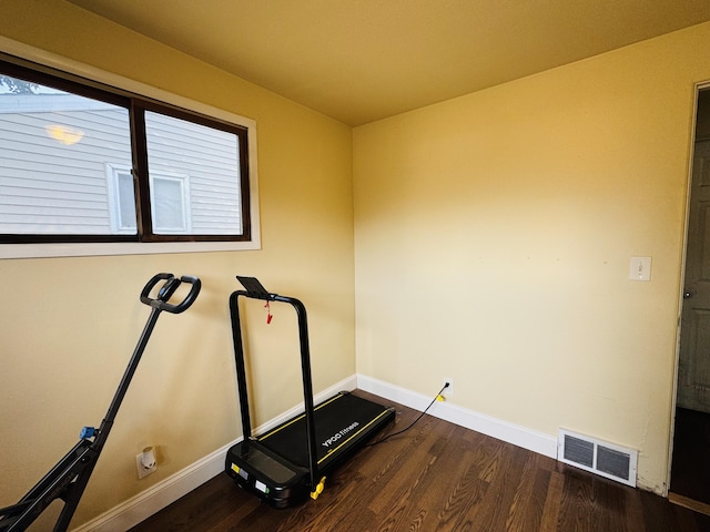 326 N Addison St, Alpena, MI 49707 - workout room featuring baseboards and wood finished floors