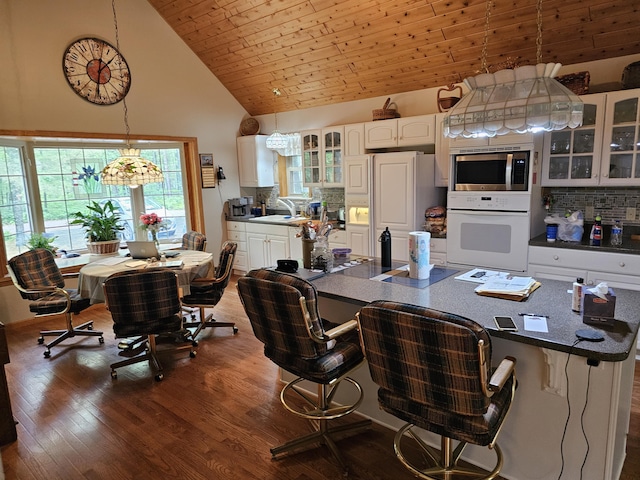 14911 Kings Ln, Ocqueoc, MI 49759 - office area featuring dark wood-style flooring and high vaulted ceiling