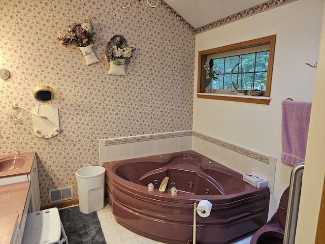 14911 Kings Ln, Ocqueoc, MI 49759 - bathroom with a tub with jets, wallpapered walls, vanity, and crown molding