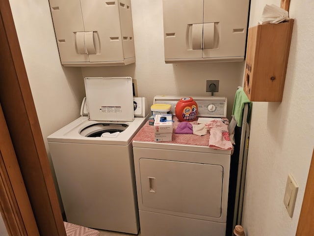 14911 Kings Ln, Ocqueoc, MI 49759 - laundry area with cabinet space and washing machine and clothes dryer