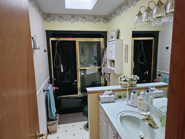 14911 Kings Ln, Ocqueoc, MI 49759 - bathroom featuring wallpapered walls, wainscoting, a skylight, and vanity