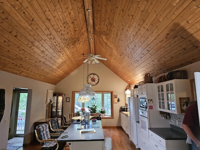 14911 Kings Ln, Ocqueoc, MI 49759 - kitchen with wood ceiling, light wood finished floors, white cabinetry, a kitchen island, and glass insert cabinets