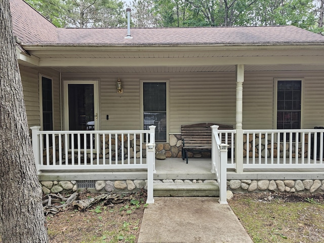 14911 Kings Ln, Ocqueoc, MI 49759 - doorway to property with a porch and roof with shingles
