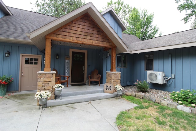 2150 Danish Landing Rd, Grayling, MI 49738 - entrance to property featuring board and batten siding, roof with shingles, and a porch